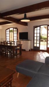 a living room with a couch and a table and chairs at L'Oustau in Cavaillon