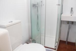 a bathroom with a shower and a toilet and a sink at xisto camping in Janeiro de Baixo
