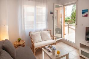 a living room with a couch and a chair at MyFlats La Palma in El Campello