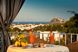 a table with drinks on it with a view of the ocean at Le Querce Resort Sea Thermae & Spa in Ischia