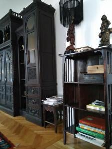 a room with black furniture and a book shelf at Casa Livia Brasov in Braşov