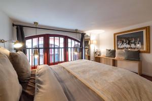 a bedroom with a large bed and a window at Architect's Triplex - Haut Marais in Paris