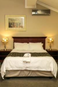 Ένα ή περισσότερα κρεβάτια σε δωμάτιο στο Mondior Manor Guest House