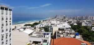 a view of a city with the ocean and buildings at Barra Beach in Rio de Janeiro