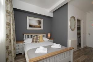 a bedroom with a bed with two towels on it at The Square townhouse Fermoy in Fermoy