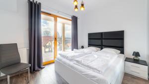 Posteľ alebo postele v izbe v ubytovaní Apartamenty Sun & Snow Sarnia Residence