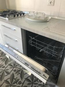 an oven with its door open in a kitchen at Casa Cardi in Sperlonga