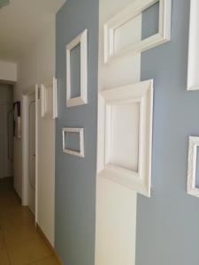 a hallway with white windows on a wall at B&B Dalla Nonna in Mattinata