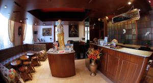 a bar in a restaurant with a statue of a woman at Hotel Victoria in Lugano