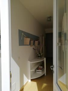 a bathroom with a shelf with towels on a wall at B&B Dalla Nonna in Mattinata