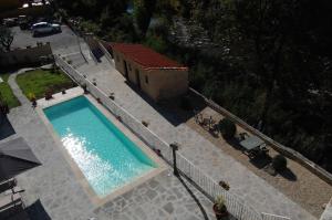 an overhead view of a swimming pool next to a house at Villa ULQINI in Bagni di Lucca