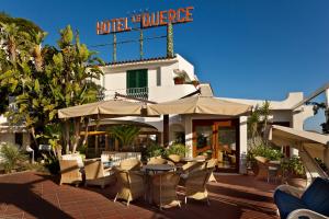 a restaurant with a table and chairs and a hotel at Le Querce Resort Sea Thermae & Spa in Ischia