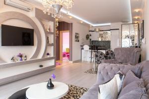 a living room with a couch and a table at Bečiči - Andrea apartman in Bečići