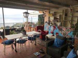 a living room with a table and chairs at B&B La Terrazza Sul Mare Taormina in Taormina