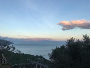 a view of the ocean from a hill at sunset at B&B La Terrazza Sul Mare Taormina in Taormina