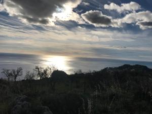 a cloudy sky with the sun in a field at B&B La Terrazza Sul Mare Taormina in Taormina