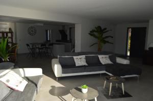 a living room with a couch and a table at Villa au coeur du Gers avec vue sur les Pyrénées in Caumont