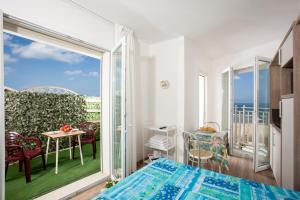 a bedroom with a balcony with a view of the ocean at Beach Residence in Gabicce Mare