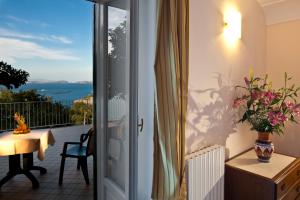 a room with a balcony with a view of the ocean at Le Querce Resort Sea Thermae & Spa in Ischia