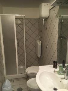 a bathroom with a toilet and a sink at Pretoria House in Potenza