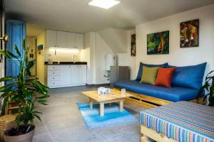 a living room with a blue couch and a table at Old Town Guesthouses-Batroun in Batroûn