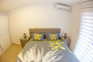 a bedroom with a bed with yellow flowers on it at Central Budva apartment in Budva