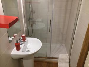 uma casa de banho com um lavatório e um chuveiro em La Barthe Haute em Puycalvel Lautrec