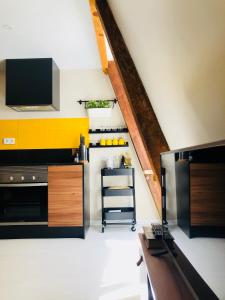 a kitchen with a black and yellow wall at Canarios Apartments Avenida in Lisbon