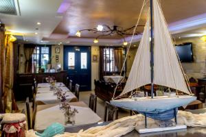 a model sailboat on a table in a restaurant at ''EPAVLIS boutique GALAXIDI'' in Galaxidi