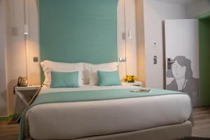 a bed with a white comforter and pillows at Be Poet Baixa Hotel in Lisbon