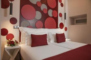 a bed with a white bedspread and pillows at Be Poet Baixa Hotel in Lisbon