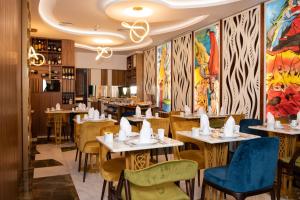 a restaurant with tables and chairs and paintings on the walls at Be Poet Baixa Hotel in Lisbon