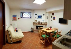 a living room with a table and a fireplace at Villa Polio in Castel di Sangro