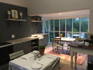 a kitchen with a table and a dining room at Lemon Tree B&B in Kloof