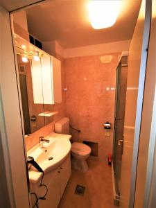 a bathroom with a sink and a toilet and a shower at Comfortable 3* Apartment Lapad Center in Dubrovnik +21 photos