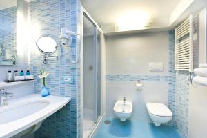 a bathroom with a sink and a toilet and a shower at Sorrento Flats in Sorrento