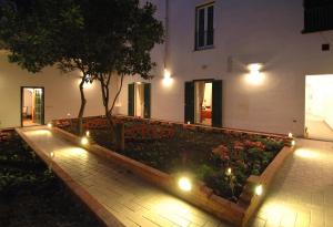a courtyard with lights and a tree in a building at Androsa Apartments in Amalfi