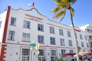 a palm tree in front of a white building at Beach Park Hotel in Miami Beach