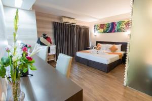 a hotel room with a bed and a table at The Cotai Luxury Design Hotel in Bang Bo