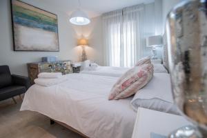 מיטה או מיטות בחדר ב-Apartamento Sueño de la Caleta
