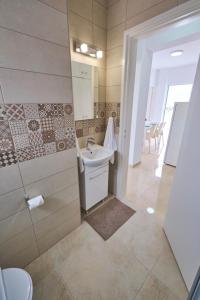 a bathroom with a sink and a shower and a toilet at FIG TREE GIANNIS in Protaras