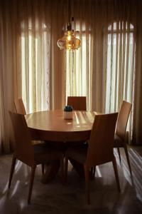 a dining room table with chairs and a chandelier at Exodus Hostel & Dive Center in Eilat