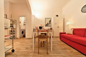 a living room with a red couch and a table at Wine Apartments Florence Colorino in Florence