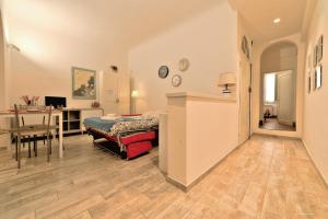 a room with a bed and a desk and a table at Wine Apartments Florence Colorino in Florence