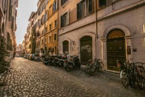 una fila di motocicli parcheggiati in una strada accanto agli edifici di Colosseum Forum apartment a Roma