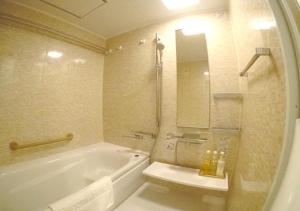 a bathroom with a tub and a toilet and a sink at Arakawa-ku - Hotel / Vacation STAY 21933 in Tokyo