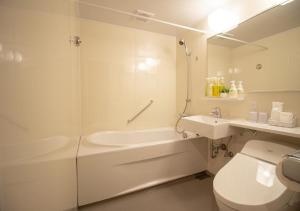 a bathroom with a toilet and a tub and a sink at Arakawa-ku - Hotel / Vacation STAY 21946 in Tokyo