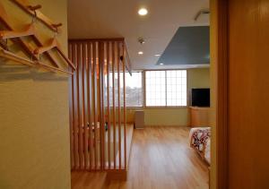 a room with a staircase and a living room at Arakawa-ku - Hotel / Vacation STAY 21933 in Tokyo