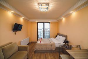 une petite pièce avec un lit et un canapé dans l'établissement New Gudauri Loft 2 #557, à Goudaouri