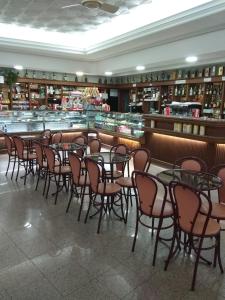 a room with tables and chairs in a restaurant at Residencial Real - Antiga Rosas in Vila Real